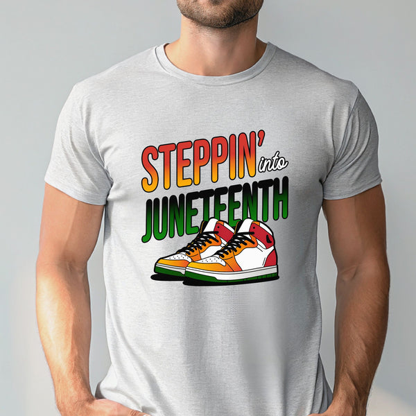 A man wearing a gray t-shirt with a graphic design featuring a pair of colorful sneakers and the text "StepPIN' into JUNEFTH".