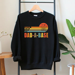 A black sweatshirt with a graphic design on it, hanging on a wooden hanger.