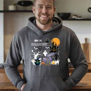 A man wearing a grey hoodie with a Halloween-themed graphic on it, smiling at the camera.