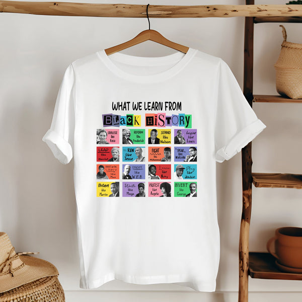 A white t-shirt with a colorful graphic design featuring a collage of black and white portraits of various historical figures, along with the text "What we learn from Black history" above the portraits.
