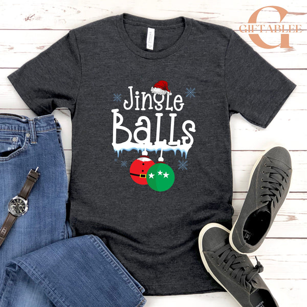 A gray t-shirt with a Christmas-themed design, including a Santa hat, snowflakes, and Christmas balls, along with a pair of jeans and sneakers.