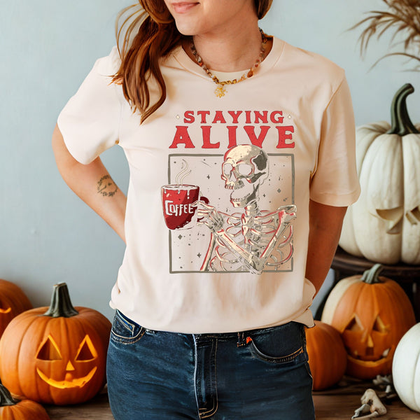 Staying Alive (Barely) – Skeleton Drinking Coffee Shirt for Caffeine Addicts
