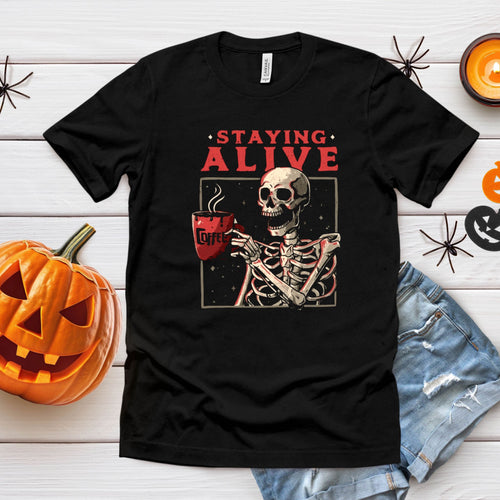 Staying Alive (Barely) – Skeleton Drinking Coffee Shirt for Caffeine Addicts