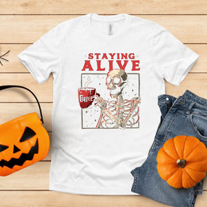 Staying Alive (Barely) – Skeleton Drinking Coffee Shirt for Caffeine Addicts