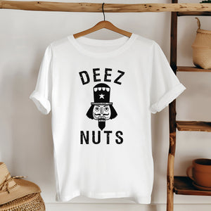 A white t-shirt with the text "DEEZ NUTS" printed on it, featuring a nutcracker or nutcracker-like character.