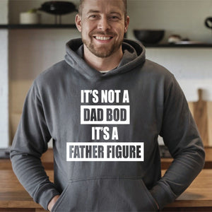 A man wearing a grey hoodie with the text "IT'S NOT A DAD BOD IT'S A FATHER FIGURE" printed on it.