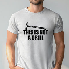A man wearing a gray t-shirt with a humorous text printed on it.