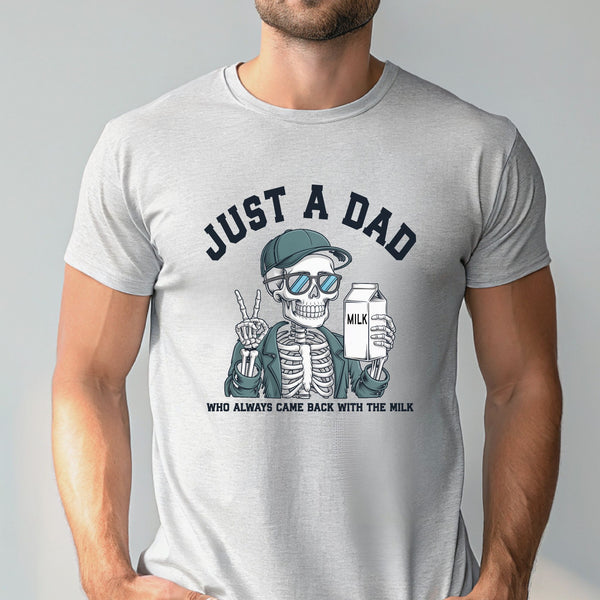 A man wearing a gray t-shirt with a graphic design depicting a skeleton wearing sunglasses and holding a carton of milk, with the text "Just a Dad" above the image.