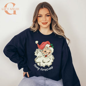 A woman wearing a navy blue sweater with a Santa Claus design and the text "Merry Christmas" printed on it.