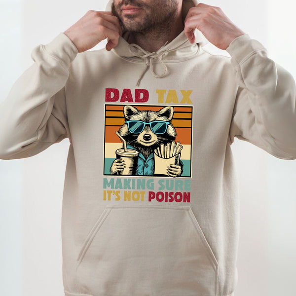 A man wearing a white hoodie with a graphic design of a raccoon wearing sunglasses and holding a drink.