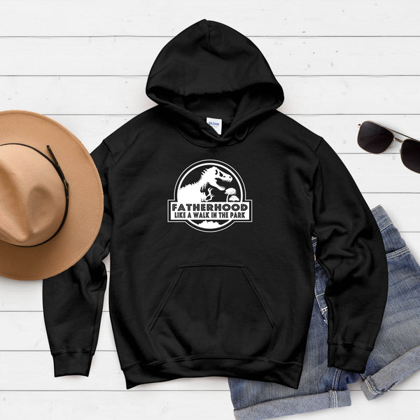 A black hoodie with a graphic design and text printed on it, along with a pair of sunglasses and a hat, all laid out on a white background.