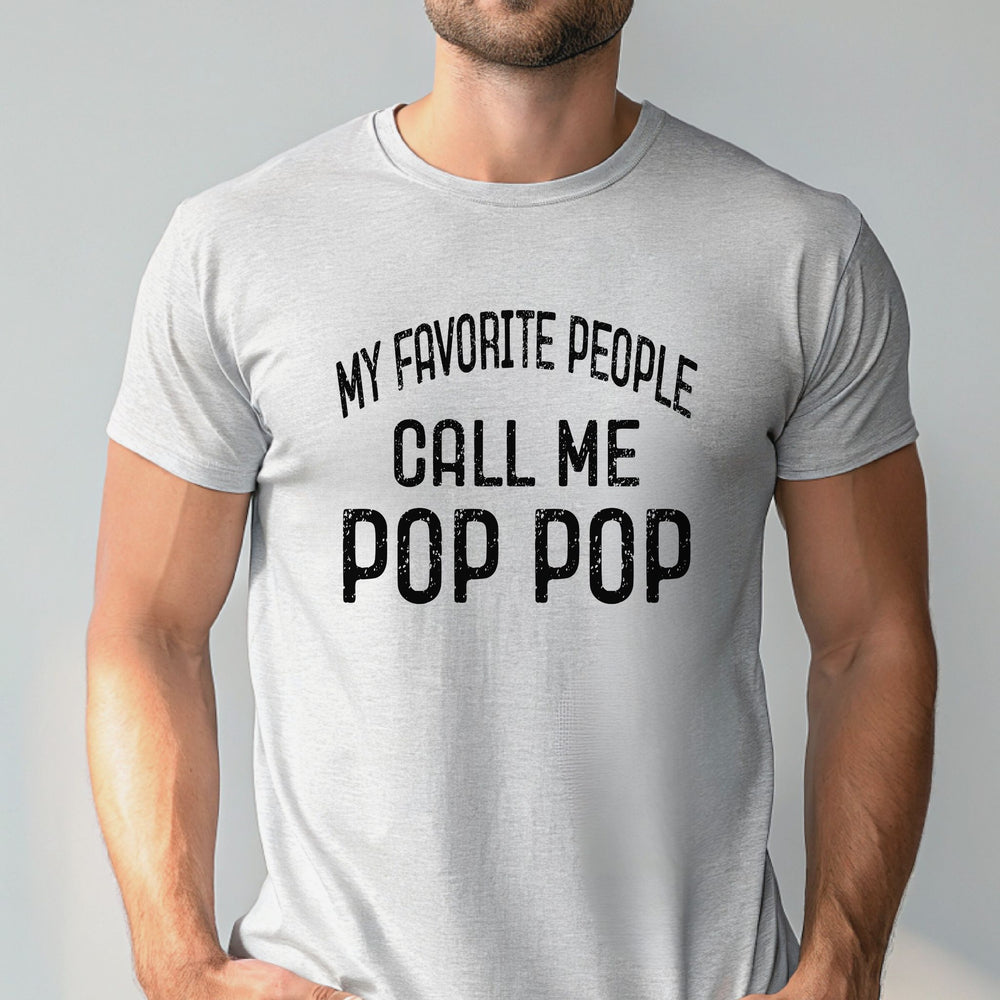 A man wearing a gray t-shirt with the text "MY FAVORITE PEOPLE CALL ME POP POP" printed on it.
