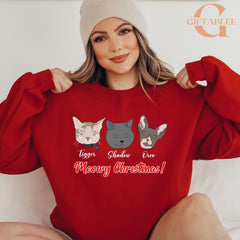 A woman wearing a red sweater with a graphic of three cats and the text "Meowy Christmas!" printed on it.