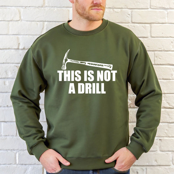 A man wearing a green sweatshirt with the text "THIS IS NOT A DRILL" printed on it.