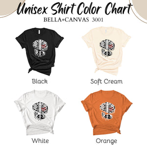 a color chart for a unisex shirt, with four different color options: black, soft cream, white, and orange.