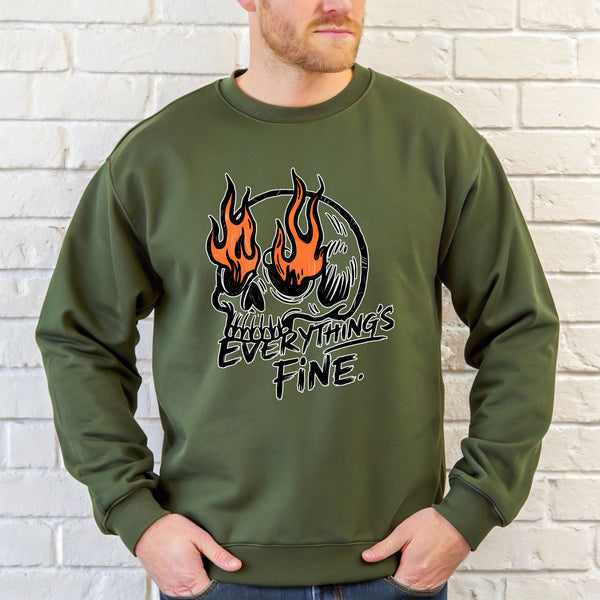 A man wearing a green sweatshirt with a graphic design featuring a skull with flames and the text "Everything's Fine" printed on it.