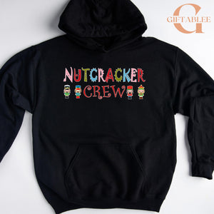 A black hoodie with the text "NUTCRACKER CREW" printed on it, along with small nutcracker figures.