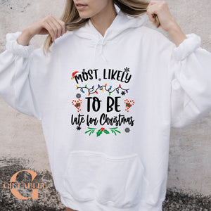 A person wearing a white hoodie with a humorous Christmas-themed text printed on it.