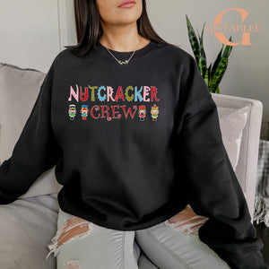 A woman wearing a black sweatshirt with the text "Nutcracker Crew" printed on it.