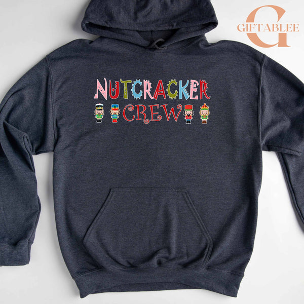 A gray hoodie with the text "NUTCRACKER CREW" printed on it, along with small nutcracker figures.