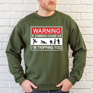 A man wearing a green sweatshirt with a warning graphic printed on it.