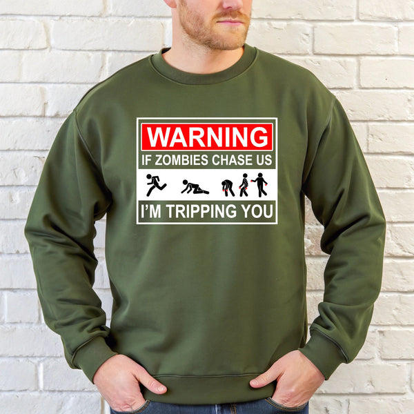 A man wearing a green sweatshirt with a warning graphic printed on it.