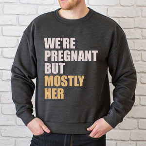 A man wearing a gray sweatshirt with text printed on it.