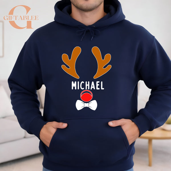 A man wearing a navy blue hoodie with a graphic design featuring a reindeer and the name "MICHAEL" printed on it.