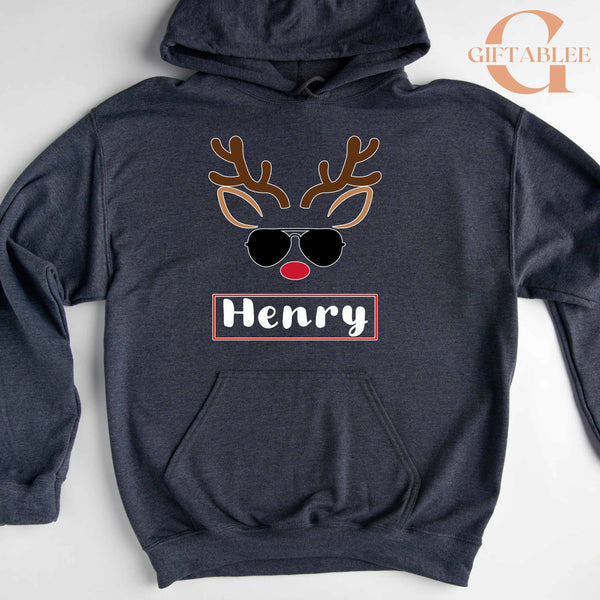 A gray hoodie with a graphic design of a reindeer wearing sunglasses and the name "Henry" printed on it.