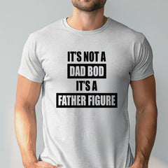 A man wearing a gray t-shirt with the text "IT'S NOT A DAD BOD IT'S A FATHER FIGURE" printed on it.