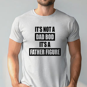 A man wearing a gray t-shirt with the text "IT'S NOT A DAD BOD IT'S A FATHER FIGURE" printed on it.