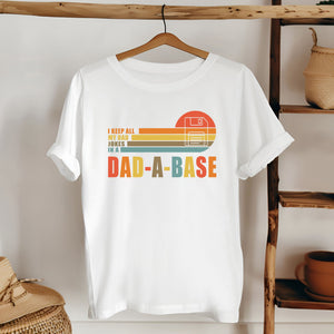 A white t-shirt with a graphic design and text printed on it, hanging on a wooden hanger.