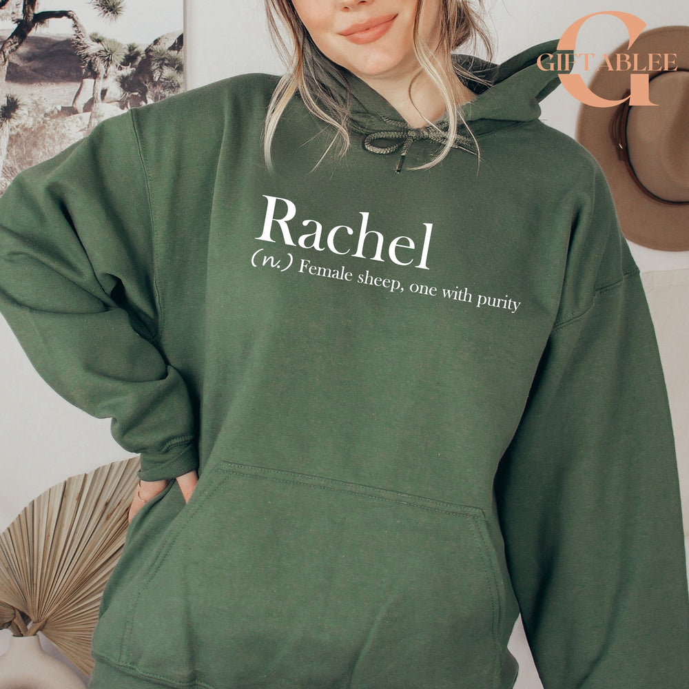 A woman wearing a green hoodie with the word "Rachael" printed on it.