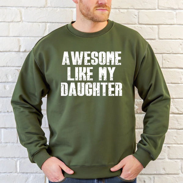 A man wearing a green sweatshirt with the text "AWESOME LIKE MY DAUGHTER" printed on it.