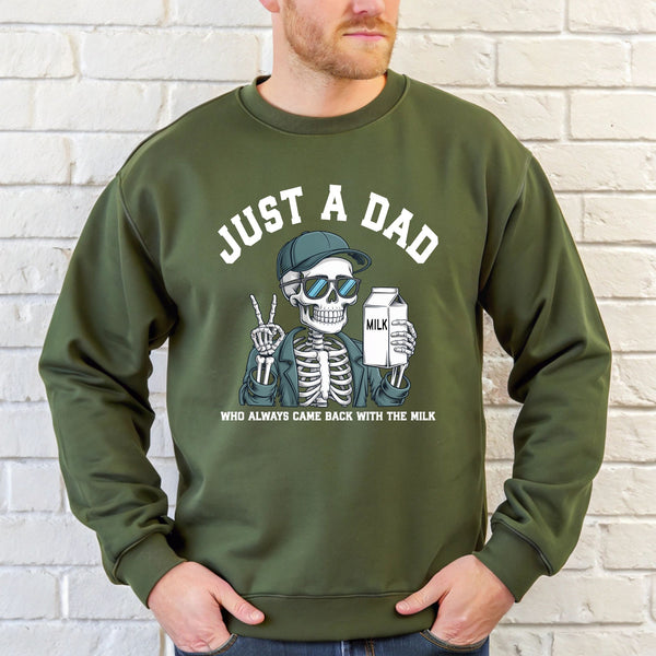 A man wearing a green sweatshirt with a graphic design of a skeleton wearing sunglasses and holding a carton of milk.