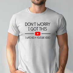 A man wearing a white t-shirt with the text "DON'T WORRY I GOT THIS I WITNESSED A YOUTUBE VIDEO" printed on it.