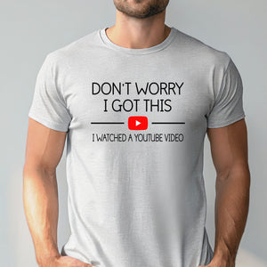 A man wearing a white t-shirt with the text "DON'T WORRY I GOT THIS I WITNESSED A YOUTUBE VIDEO" printed on it.