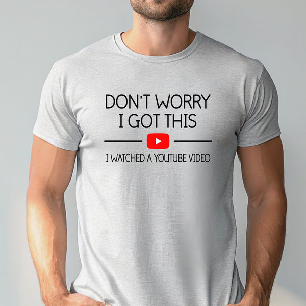 A man wearing a white t-shirt with the text "DON'T WORRY I GOT THIS I WITNESSED A YOUTUBE VIDEO" printed on it.