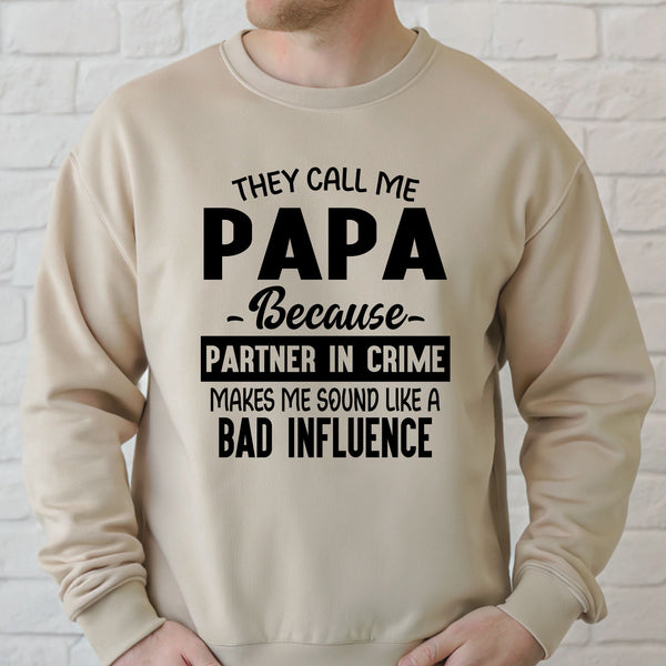 a man wearing a beige sweater with a humorous text printed on it.