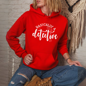 A person wearing a red hoodie with the text "BASICALLY A DETECTIVE" printed on it.
