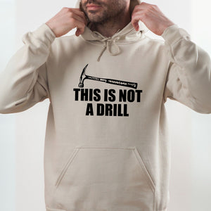 A man wearing a beige hoodie with a humorous text printed on it.