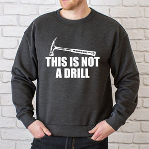 A man wearing a grey sweatshirt with a humorous text printed on it.