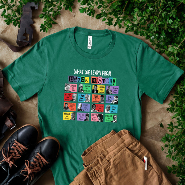 a green t-shirt with a graphic design of various people and the text "WHAT WE LEARN FROM BLACK HISTORY" printed on it, along with a pair of brown pants and black shoes.