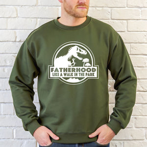 A man wearing a green sweatshirt with a graphic design and text printed on it.
