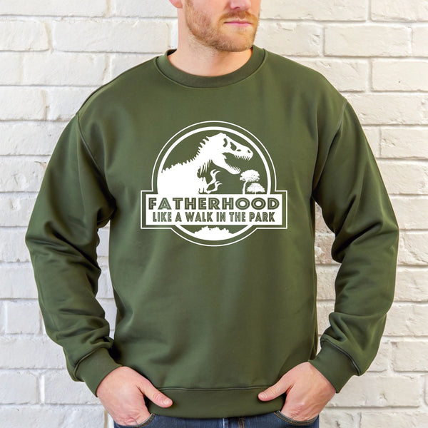 A man wearing a green sweatshirt with a graphic design and text printed on it.