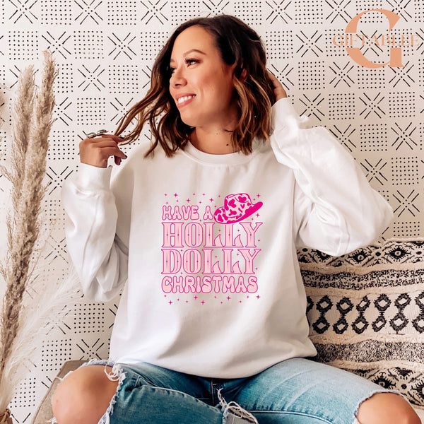 A woman wearing a white sweatshirt with a pink and white design and text, sitting on a patterned couch.