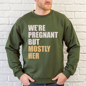 A man wearing a green sweatshirt with text printed on it.