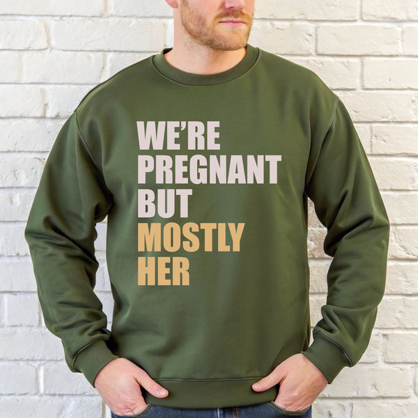 A man wearing a green sweatshirt with text printed on it.