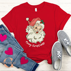A red t-shirt with a Santa Claus graphic and the text "Merry Christmas" printed on it, along with a pair of jeans and gray sneakers.