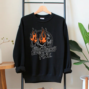 A black sweatshirt with a graphic design featuring a skull with flames and the text "EVERYTHING'S FINE" printed on it.